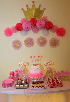 a pink and gold princess birthday party with cake, cupcakes, napkins and decorations