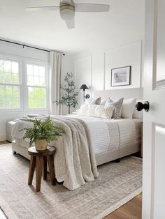 a bedroom with white walls and carpeted flooring has a large bed in the corner