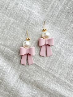 two pairs of pink bow earrings with pearls on the earwires and gold plated hooks