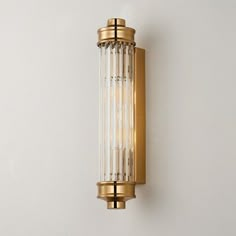 a wall mounted light on the side of a white wall