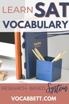 an open book sitting on top of a desk next to a pen and pencil holder