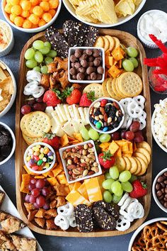 a platter filled with lots of different types of snacks and desserts on it