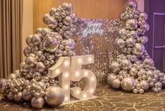 a table topped with silver balloons and numbers