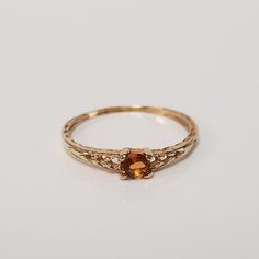 "Thanks for shopping our vintage estate store. We tend to sell well below wholesale and truly hope you enjoy all of our items. Many of the items are one of a kind, so please enjoy scrolling through the pictures and hopefully something will catch your eye. Brown spots are from reflections. Estate 14k yellow gold created .10ct orange citrine midi or baby ring. Ring size: 3 Setting: 3mm 1/8\" Band width: 1.3mm Weight: .65 gram Beautiful ring. Marked 14k." Vintage 14k Gold Sapphire Birthstone Ring, Vintage Yellow Gold Hallmarked Birthstone Ring, Vintage Hallmarked Yellow Gold Birthstone Ring, Classic Yellow Gold Citrine Birthstone Ring, Vintage Gold Topaz Birthstone Ring, Classic Citrine Birthstone Ring In Yellow Gold, Vintage Gold Topaz Promise Ring, Vintage Topaz Birthstone Promise Ring, Classic Topaz Ring With Birthstone In Round Band