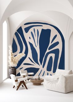 a living room with blue and white wallpaper, two chairs and a coffee table