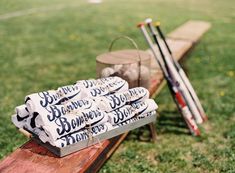 some baseballs are sitting on a bench in the grass and ready to be played