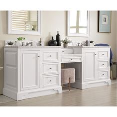 a white bathroom with two sinks and mirrors