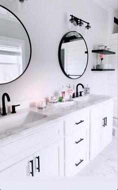 a bathroom with two sinks and mirrors in it