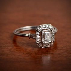 a diamond engagement ring on a wooden table