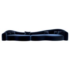 a black couch with pillows on top of it