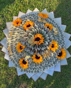 a bunch of sunflowers are arranged in the shape of a large flower arrangement