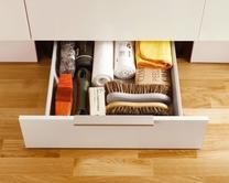 an open drawer in the middle of a wooden floor