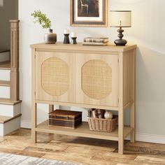 a wooden cabinet with wicker doors and two baskets on the bottom shelf next to it