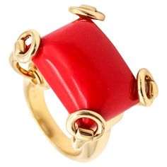 Cocktail ring designed by Gucci. Iconic and popular horse-bits cocktail ring, created in Milano Italy by the fashion and jewelry house of Gucci. This large cocktail ring has been crafted in solid yellow gold of 18 karats with high polished finish. The setting is designed, with horse bits patterns that are holding on top a large carved coral. Coral: Mounted in the center, with 1 rectangle cabochon cut (15.5 x 20.3 x 11.5 mm) of a red coral of 24.45 carats. Weight: 24.65 Grams, (15.81 Dwt). Size: 6.5 and can be sized. Measurements: 26 mm by 21 mm (1.02 x 0.83 Inches) and raise 15 mm over the finger. Hallmarks: Stamped with the maker's mark, the Italian gold assay mark and signed in full, "GUCCI MADE IN ITALY .750 10 *3749AL". Gucci This company was founded in 1921 in the Tuscany region of It Gucci High Jewelry, Aldo Gucci, Cocktail Ring Designs, House Of Gucci, Milano Italy, Horse Bits, Leather Luggage, Geek Chic, Red Coral