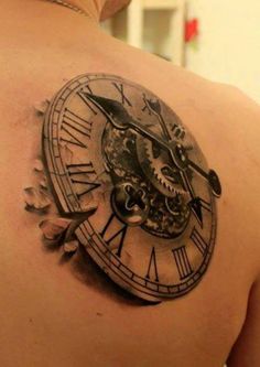 an image of a clock tattoo on the back of a man's shoulder and chest