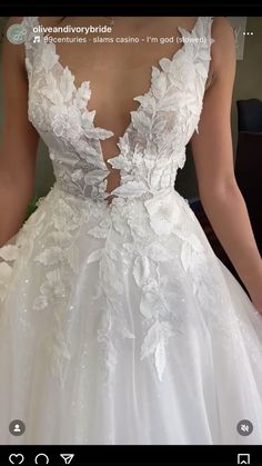 the back of a wedding dress with flowers on it