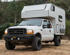 a white truck with a camper attached to it