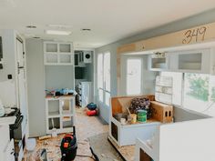 an unfinished kitchen and living room in a house being remodeled with new cabinets, appliances, and flooring