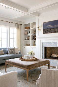 a living room filled with furniture and a fire place