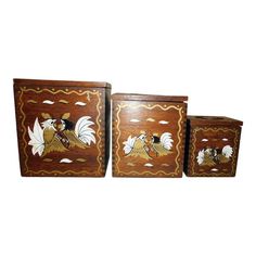 three wooden boxes with designs on them