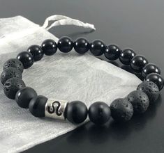 Available in all Zodiac Signs. - Please select ZODIAC in the personalization section. Black Onyx & Black Lava  (8mm or 6mm ) Healing Crystal Bracelet with Leo Zodiac Bead  ❤️ All Bracelets are Crafted from High Quality GENUINE Gemstone Beads sourced from Reputable Healing Crystal Suppliers. You are buying a Handmade High Quality Gemstone Stretch Bracelet  Handmade with Lots of Love & Positive Energy Includes:  Strong Durable 1mm Stretch Cord White Organza gift bag Detailed Crystal Information  C Leo Zodiac Jewelry, Leo Bracelet, Leo Jewelry, Pyrite Bracelet, Bracelet Gift Box, Lava Bead Bracelet, Black Onyx Bracelet, Zodiac Bracelet, Lava Bracelet