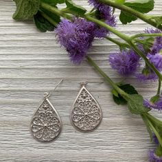 These silver teardrop filigree earrings feature an intricate pattern that adds a touch of elegance to any outfit. The teardrop design is perfect for both casual and formal occasions, making these earrings a versatile addition to your jewelry collection. Lightweight and comfortable, these earrings are crafted with attention to detail, ensuring you look stylish and sophisticated. The earrings hang 1 1/4" long from silver plated ear wires. Elegant Silver Teardrop Crown Earrings, Metal Teardrop Filigree Earrings, Bohemian Silver Filigree Teardrop Earrings, Elegant Filigree Teardrop Drop Earrings, Silver Filigree Teardrop Earrings For Wedding, Silver Filigree Teardrop Earrings For Gift, Sterling Silver Teardrop Earrings With Intricate Design, Sterling Silver Intricate Teardrop Earrings, Silver Teardrop Earrings With Intricate Design