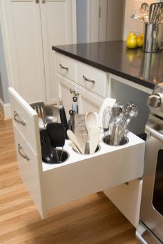 an appliance drawer is open to show the kitchen utensils in it