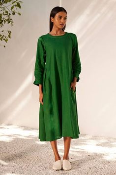 Forest green midi dress with gathers on the sides and smocking detail on the sleeves.
Components: 1
Pattern: Embroidered
Type Of Work: Running Stitches
Neckline: Round
Sleeve Type: Long
Fabric: Linen
Color: Green
Other Details: 
Embroidered neckline
Side seam pockets
Closure: Back zipper
Occasion: Resort,Party - Aza Fashions Spring Dark Green Midi Dress, Green Maxi Dress With Gathered Sleeves, Dark Green Knee-length Midi Dress For Summer, Casual Dark Green Midi Dress For Spring, Green Relaxed Fit Dress For Fall, Casual Green Tunic Dress, Dark Green Midi Length Dress For Spring, Dark Green Midi Length Spring Dress, Green Spring Dress With Pleated Sleeves