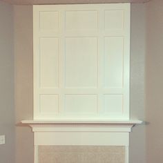 the fireplace is painted white and has no mantle