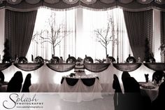 a black and white photo of an elegant dining room