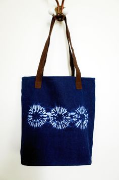 a blue tote bag hanging from a hook