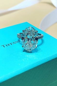 a diamond ring sitting on top of a blue box