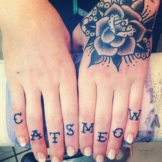 two hands with tattoos on them and the words cats meow written in black ink