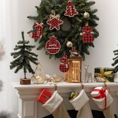 christmas stockings and decorations are hanging on the mantle