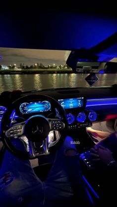 the interior of a car is lit up with blue lights