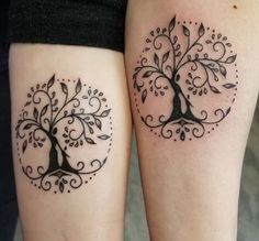 two people with tattoos on their legs, one has a tree and the other has leaves