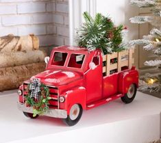 a red truck with a christmas tree in the back