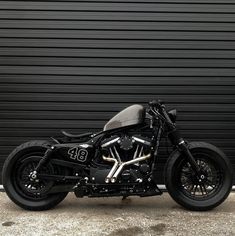 a black motorcycle parked in front of a garage door