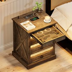 a wooden table with some glasses on it and a magazine in the drawer next to it