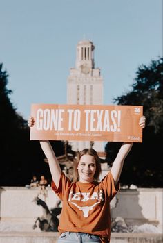 a woman holding up a sign that says gone to texas