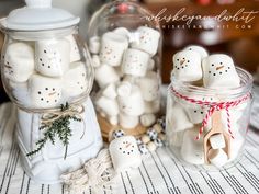 some marshmallows are in a glass jar on a table with other marshmallows