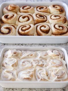 two pans filled with cinnamon rolls sitting on top of a counter