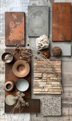 an assortment of different items are arranged on a table with metal plates and bowls in front of them