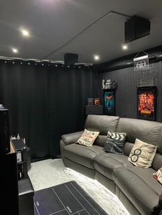 a room that has a couch and some pictures on the wall in it with lights