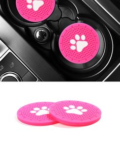 two pink wheels with paw prints on them and the inside of a car door handle