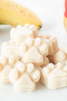 some white dog paw candy next to bananas