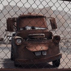 an old rusty car behind a chain link fence in the movie cars 3, starring mater from disney pixama