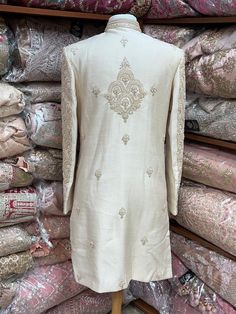 This beige white royal sherwani is brought into limelight with fine jaal embroidered coat enhanced with resham, pearl ,stone & cut dana work. The coat is styled with matching churidar pants. Size:40,42,44 Occasion: Wedding Ceremony or Reception WASH CARE INSTRUCTIONS - Please Dry clean only when it is applicable. Slight color variation is possible due to digital photography. Ready to Ship! Semi-stitched Raw Silk Sherwani With Intricate Embroidery, Elegant Raw Silk Sherwani With Intricate Embroidery, Beige Sherwani With Zari Work, Traditional Drape, Designer Sherwani With Intricate Embroidery And Straight Kurta, Traditional Raw Silk Sherwani With Intricate Embroidery, Elegant Raw Silk Sherwani With Traditional Drape, Eid Raw Silk Sherwani With Intricate Embroidery, Beige Sherwani With Resham Embroidery, Eid Sherwani With Intricate Embroidery In Raw Silk