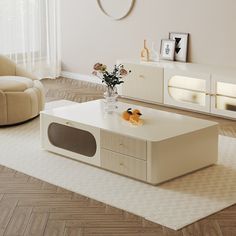 a living room with a white coffee table and beige couches in front of a large window