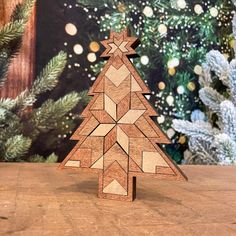 a wooden christmas tree on a table